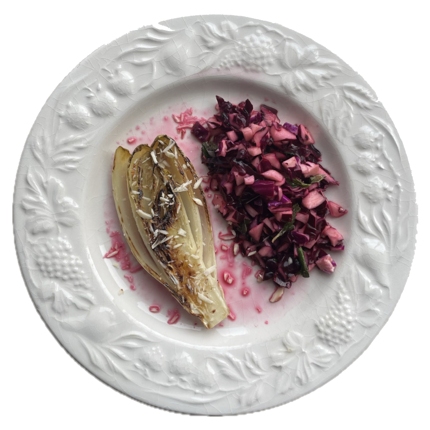 Charred endive and red cabbage on an embossed white plate